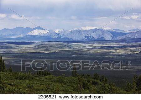 Stock Image - Storm Light On The Ogilvie Mountains Along The Dempster Highway; Yukon Canada. Fotosearch