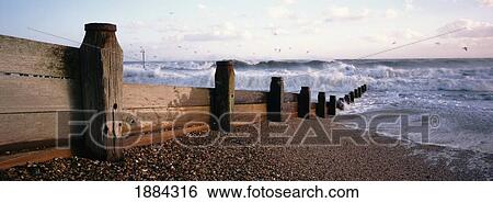Stock Photograph - Stormy Seas Hitting Groynes. Fotosearch