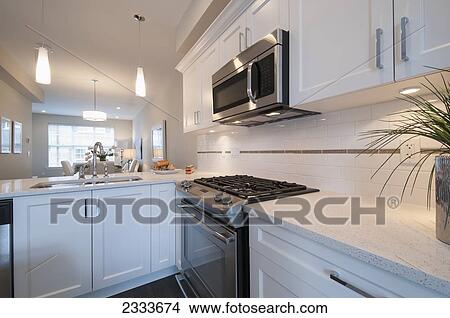 Stove And Built-In Microwave Oven In Modern Kitchen; Surrey, British Columbia, Canada View Large Photo Image Picture - Stove And Built-In Microwave Oven In Modern Kitchen; Surrey, British Columbia, Canada. Fotosearch