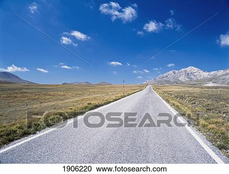 Stock Image - Straight, Empty Road Through The Campo Imperatore, Parco Nazionale Del Gran Sasso, Abruzzo, Italy.. Fotosearch