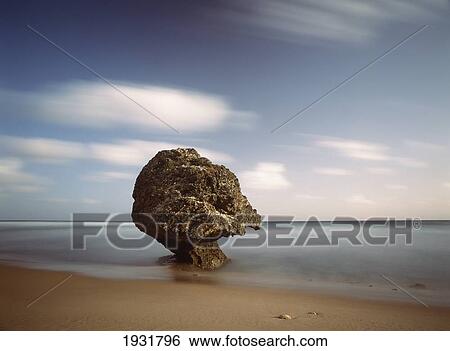 Stock Photograph - Strange Shaped Rock At Dawn Off The Beach Of Bathsheba, Barbados; Barbados. Fotosearch