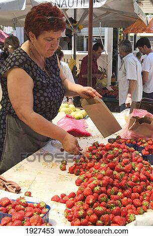 Stock Image - Strawberry Seller In Market; Split, Split-Dalmatia County, Croatia. Fotosearch