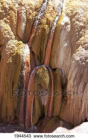 Stock Image - Stream flowing over sulphur deposits left by the Vacas River, Puente del Inca, Mendoza, Argentina. Fotosearch
