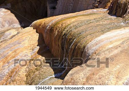Stock Photo - Stream flowing over sulphur deposits left by the Vacas River, Puente del Inca, Mendoza, Argentina. Fotosearch