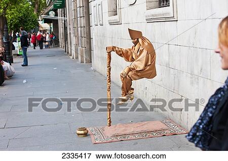 Street Artist Performing Trick During April Feria Festival; Seville, Andalucia, Spain, Europe View Large Photo Image Stock Photo - Street Artist Performing Trick During April Feria Festival; Seville, Andalucia, Spain, Europe. Fotosearch