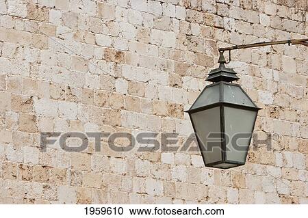 Stock Image - Street Lantern Against Brick Wall At Dubrovnik, Dubrovnik-Neretva, Croatia. Fotosearch