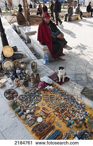 Stock Image - Street Market Trader With His Cat, Amman, Jordan, Middle East. Fotosearch