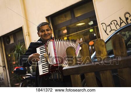 Stock Image - Street Musician Playing Accordion; Rome, Italy. Fotosearch