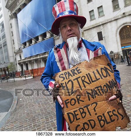 Stock Photo - Street Performer Begging On Wall Street, New York Stock Exchange, Manhattan, New York, Usa. Fotosearch