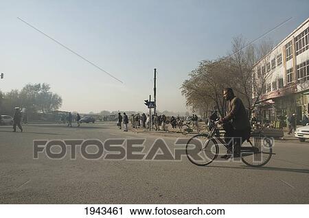 Stock Image - Street Scene With A Man On A Bicycle In Kabul,, Afghanistan. Fotosearch