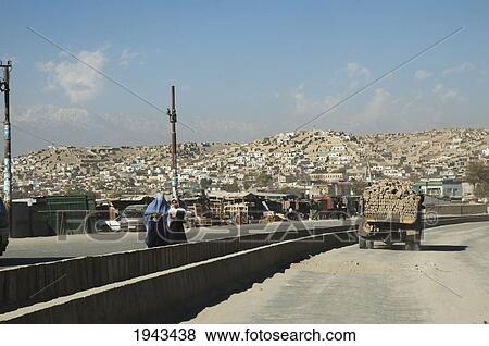 Stock Photo - Street Scene With Afghan Woman And A Truck Loaded With Bricks In Kabul,, Afghanistan. Fotosearch