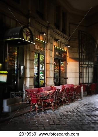 Stock Photo - Street Scene With Coffee Tables At Night; Paris France. Fotosearch