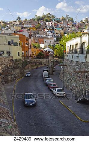 Stock Photo - Street scene with homes on the hillside; Guanajuato, Mexico. Fotosearch