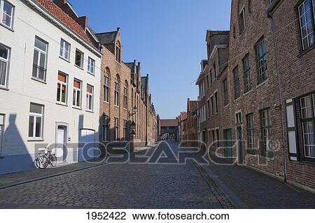 Stock Image - Street scene with Medieval houses, Bruges (Brugge), West Flanders, Belgium. Fotosearch