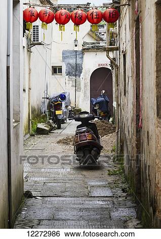 Stock Photograph - Street scene with motorcycles, Hongcun, Anhui, China. Fotosearch