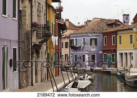 Stock Image - Street Scenes Of Colorful Homes Along The Canal In Burano, A Small Island Off Venice, Italy. Fotosearch