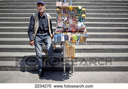 Stock Image - Street Vendor sells an assortment of useful items on the steps of the subway, Eminonu, stanbul. Fotosearch