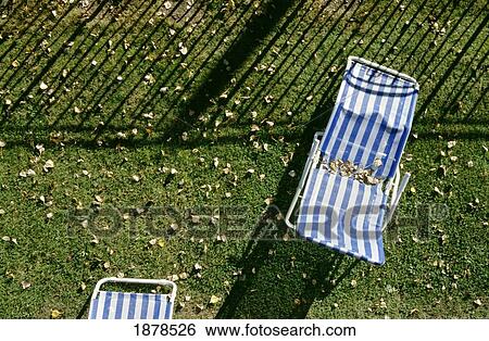 Striped Deckchairs On Grass With Autumn Leaves View Large Photo Image Stock Photograph - Striped Deckchairs On Grass With Autumn Leaves. Fotosearch