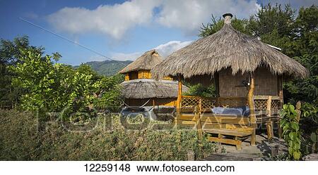 Structure with thatch roof for sun shade at beach resort; Atauro Island, Timor-Leste View Large Photo Image Stock Photo - Structure with thatch roof for sun shade at beach resort; Atauro Island, Timor-Leste. Fotosearch