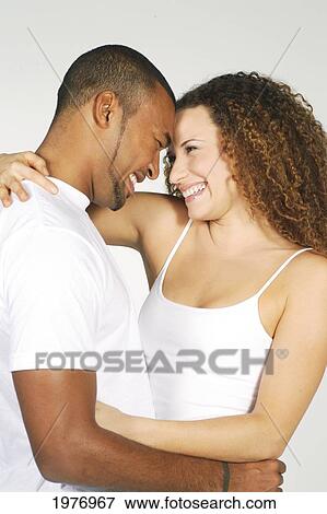 Stock Photo - Studio Image Of Couple Smiling.. Fotosearch