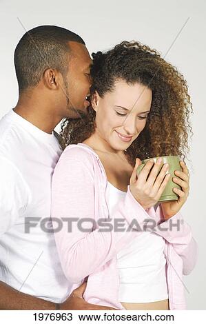 Studio Image Of Couple Whispering With Coffee Cup. View Large Photo Image Stock Image - Studio Image Of Couple Whispering With Coffee Cup.. Fotosearch