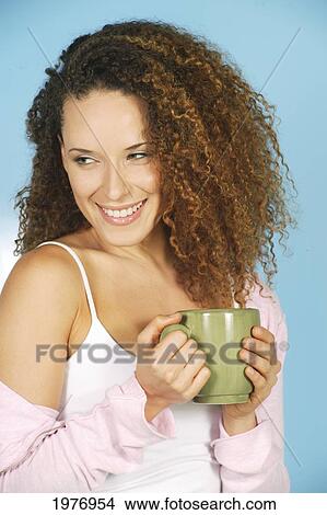 Picture - Studio Image Of Girl With Green Coffee Mug.. Fotosearch