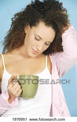 Stock Image - Studio Image Of Girl With Green Coffee Mug.. Fotosearch