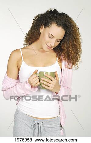 Stock Photo - Studio Image Of Girl With Green Coffee Mug.. Fotosearch