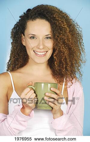 Stock Photography - Studio Image Of Girl With Green Coffee Mug.. Fotosearch