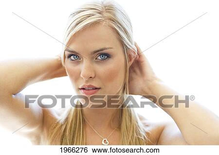 Stock Photograph - Studio Portrait Of Beautiful Blond Woman, White Background.. Fotosearch