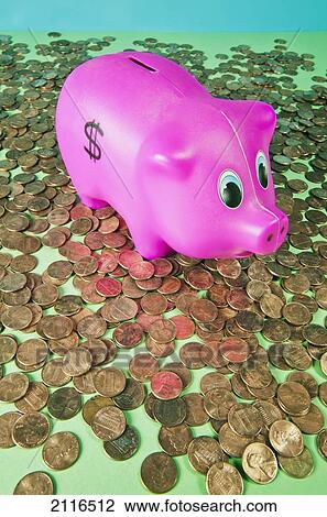 Stock Image - Studio shot of a childs piggy bank surrounded by pennies.. Fotosearch