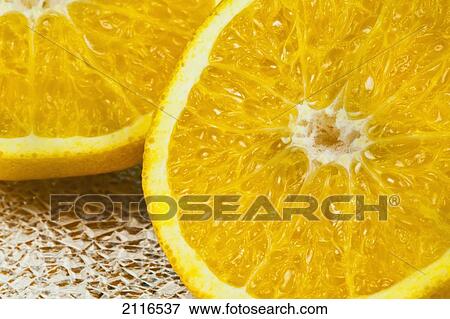 Stock Photo - Studio shot of two orange halves on a shiny background.. Fotosearch