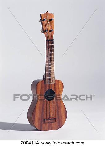 Picture - Studio Shot With White Background Of Kamaka Ukulele Standing, Shadow. Fotosearch