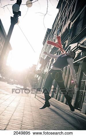 Stock Photography - Stylish Businessman Jumping In The Street, Gastown, Vancouver, British Columbia. Fotosearch