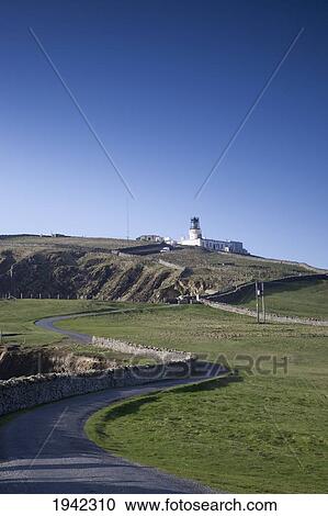 Stock Image - Sumburgh Head Lighthouse And A Winding Road; Shetland Scotland. Fotosearch