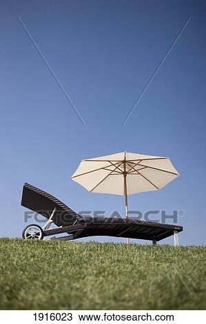 Stock Image - Sun Lounger And Umbrella. Fotosearch