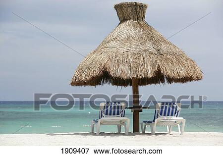 Sun Loungers And Thatched Umbrella At Beach, Mayan Riviera, Quintana Roo State, Yucatan Peninsular, Mexico View Large Photo Image Stock Photo - Sun Loungers And Thatched Umbrella At Beach, Mayan Riviera, Quintana Roo State, Yucatan Peninsular, Mexico. Fotosearch