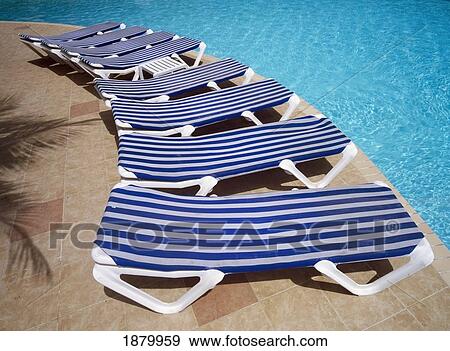 Stock Photo - Sun Loungers Arranged Around The Pool. Fotosearch