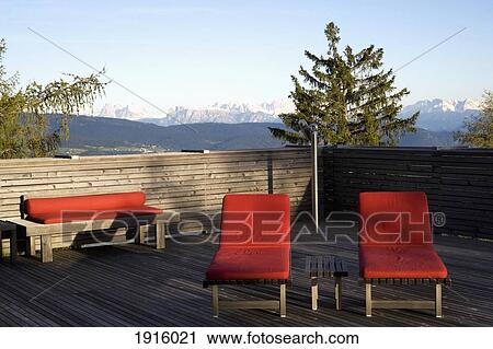 Stock Image - Sun Loungers With Mountains. Fotosearch