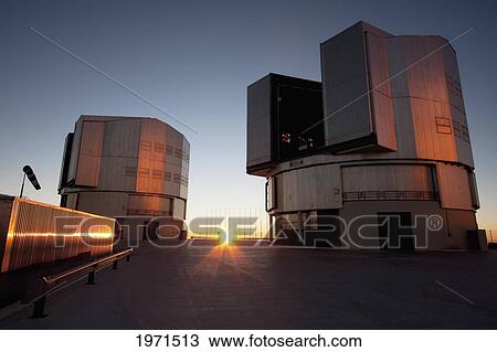 Stock Image - Sun Unit Telescope 1 & Moon Unit Telescope 2, Belonging To The Very Large Telescope (Vlt) Operated By The European Southern Observatory On Cerro Paranal At Sunset, Antofagasta Region, Chile. Fotosearch