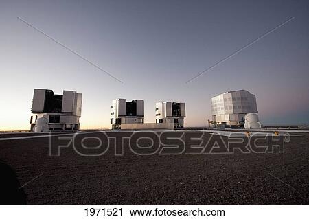Stock Image - Sun Unit Telescope 1, Moon Unit Telescope 2, Southern Cross Unit Telescope 3 & Venus Unit Telescope 4 Belonging To The Very Large Telescope (Vlt) Operated By The European Southern Observatory On Cerro Paranal At Dusk, Antofagasta Region, Chile. Fotosearch