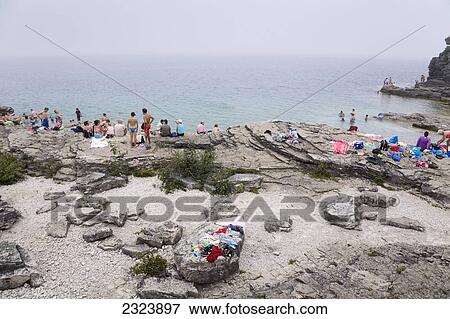 Sunbathers on a rocky beach overlooking Georgian Bay in Bruce Peninsula National Park; Ontario, Canada View Large Photo Image Stock Photo - Sunbathers on a rocky beach overlooking Georgian Bay in Bruce Peninsula National Park; Ontario, Canada. Fotosearch