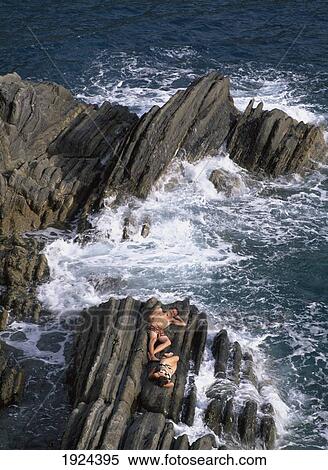 Stock Photography - Sunbathers On Rocks Near Manarola. Fotosearch
