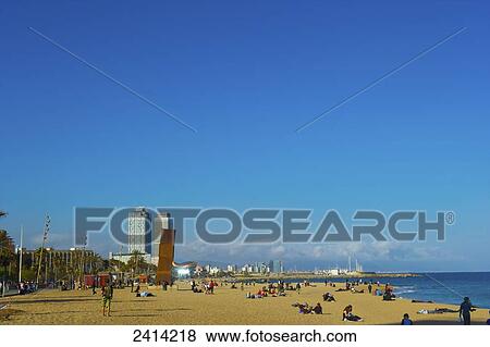 Stock Photo - Sunbathers on the beach; Barcelona, Spain. Fotosearch