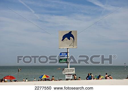Stock Image - Sunbathers on the beach; Broadstairs, Kent, England. Fotosearch