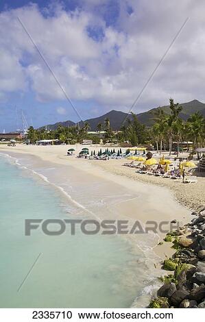 Sunbathers Sitting In Lounge Chairs With Umbrellas On The Beach; Simpson Bay, St. Martin, French West Indies View Large Photo Image Stock Image - Sunbathers Sitting In Lounge Chairs With Umbrellas On The Beach; Simpson Bay, St. Martin, French West Indies. Fotosearch