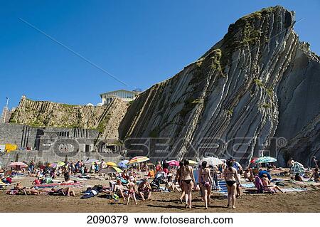 Stock Photo - Sunbathing At Itzurun Beach, Zumaia, Basque Country, Spain. Fotosearch