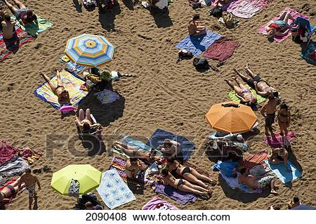 Stock Photo - Sunbathing In Itzurun Beach, Zumaia, Basque Country, Spain. Fotosearch