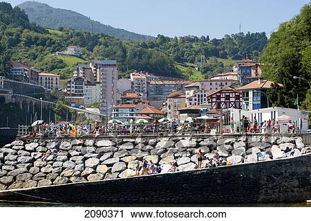 Stock Image - Sunbathing In The Cantabrian Coast, Mutriku, Basque Country, Spain. Fotosearch