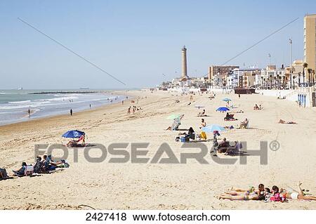 Sunbathing on the beach; Chipiona, Andalucia, Spain View Large Photo Image Stock Photo - Sunbathing on the beach; Chipiona, Andalucia, Spain. Fotosearch